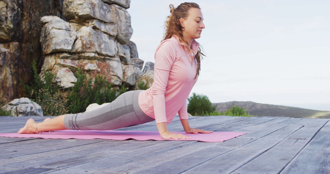 Young Woman Practicing Outdoor Yoga in Cobra Pose on Pink Mat - Free Images, Stock Photos and Pictures on Pikwizard.com