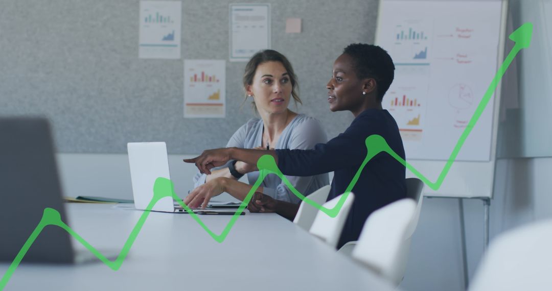 Diverse Female Colleagues Analyzing Business Growth with Graphs