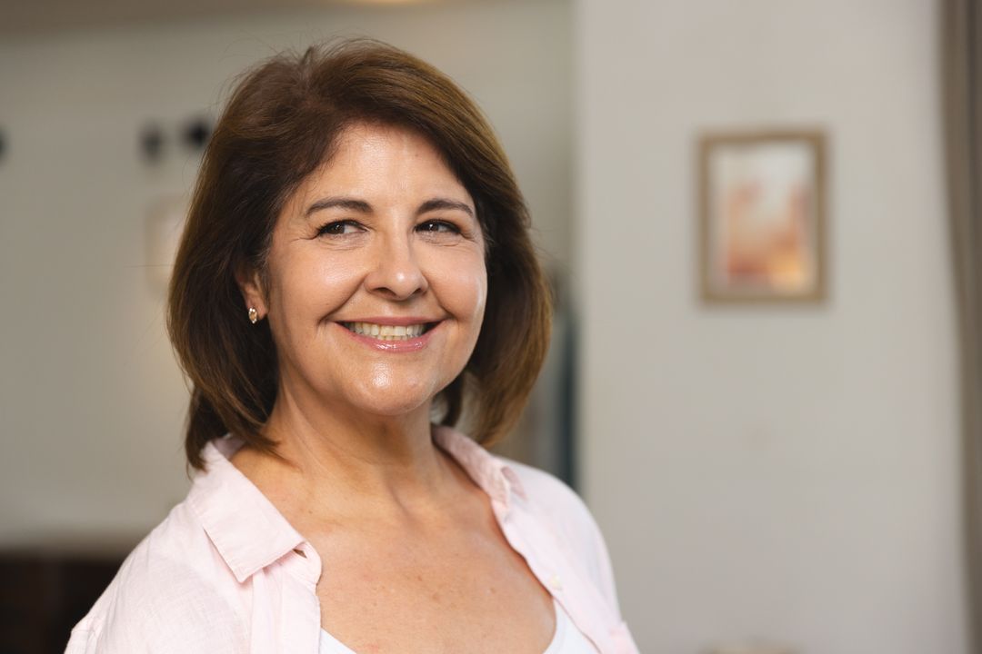 Elegant Older Hispanic Woman Smiling Indoors with Warm Expression
