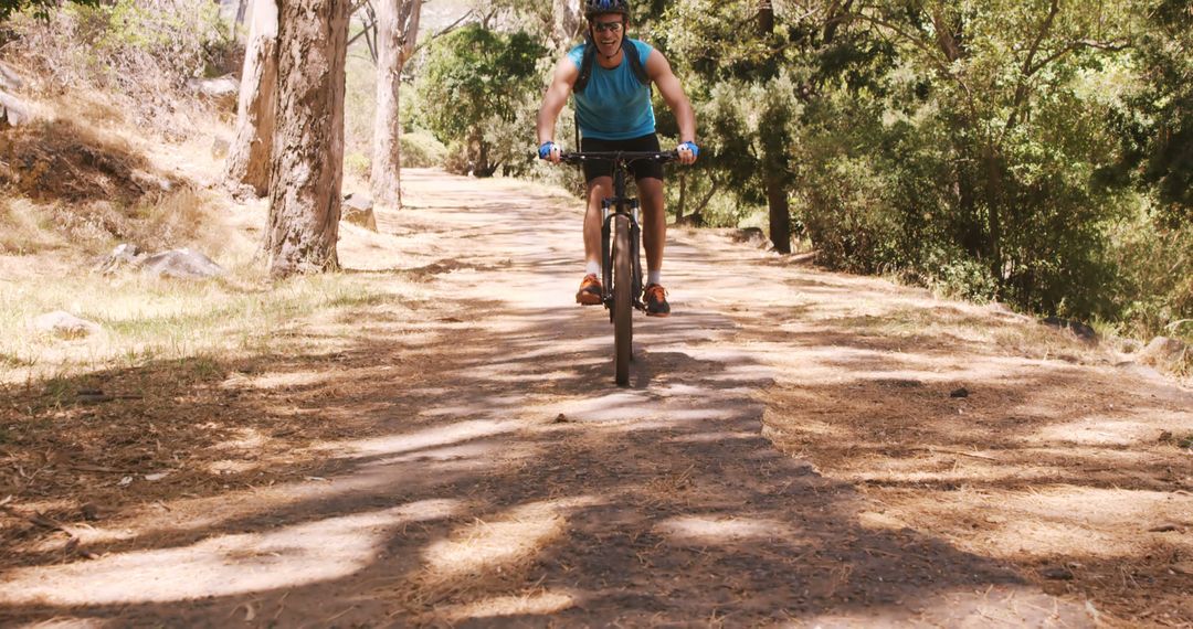 Man Cycling on Forest Trail in Sunny Weather - Free Images, Stock Photos and Pictures on Pikwizard.com