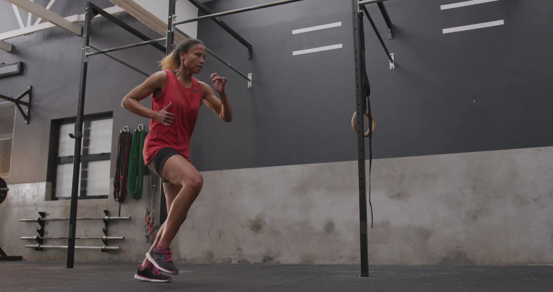 Woman Doing High-Knee Exercise in Industrial Gym Environment