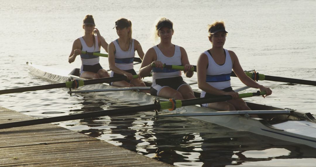 Women's Rowing Team Practicing at Sunrise on Tranquil Lake