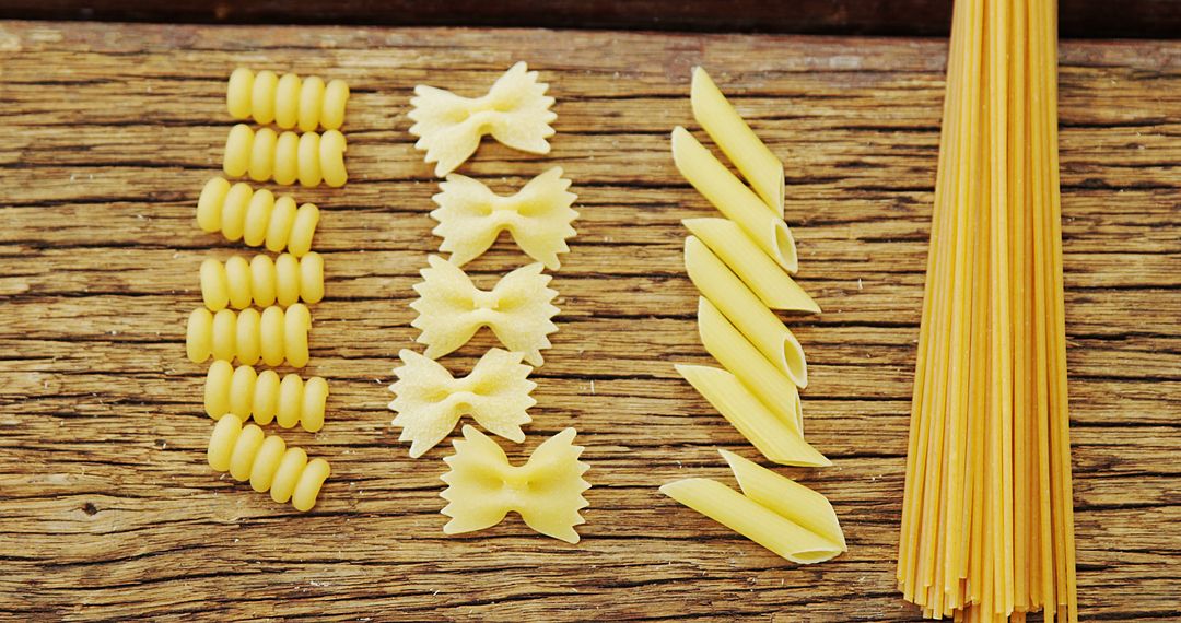 Variety of Raw Pasta on Wooden Table - Free Images, Stock Photos and Pictures on Pikwizard.com