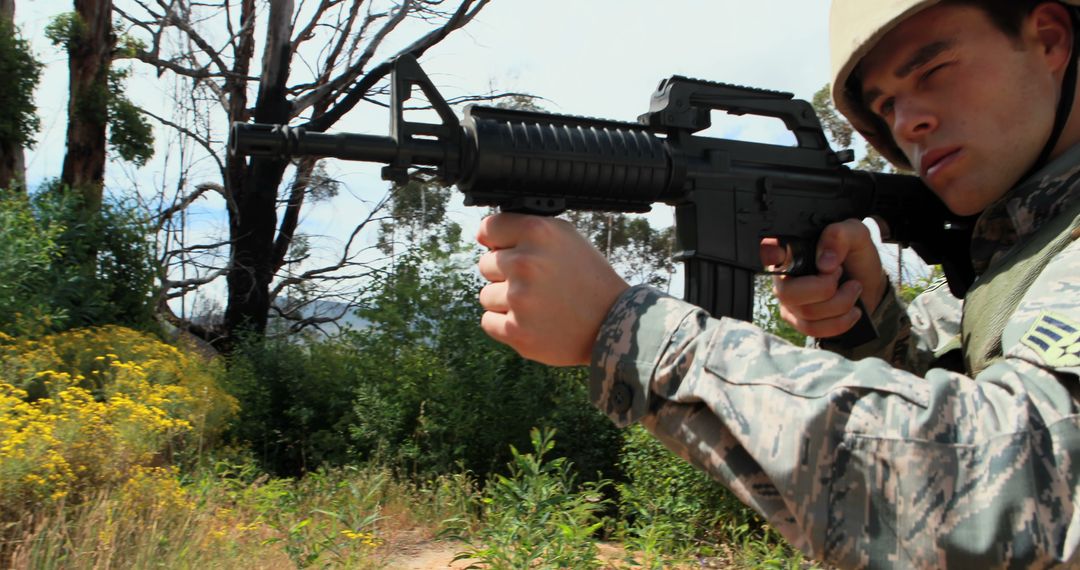 Soldier Aiming Rifle in Forested Area - Free Images, Stock Photos and Pictures on Pikwizard.com