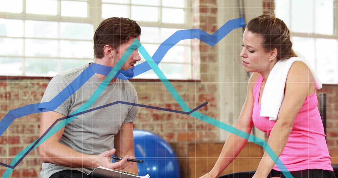 Instructor Discussing Fitness Goals with Client in Gym Facility