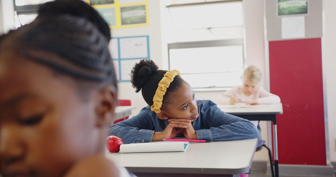 Curious Student Daydreaming in Classroom with Notebook and Apple
