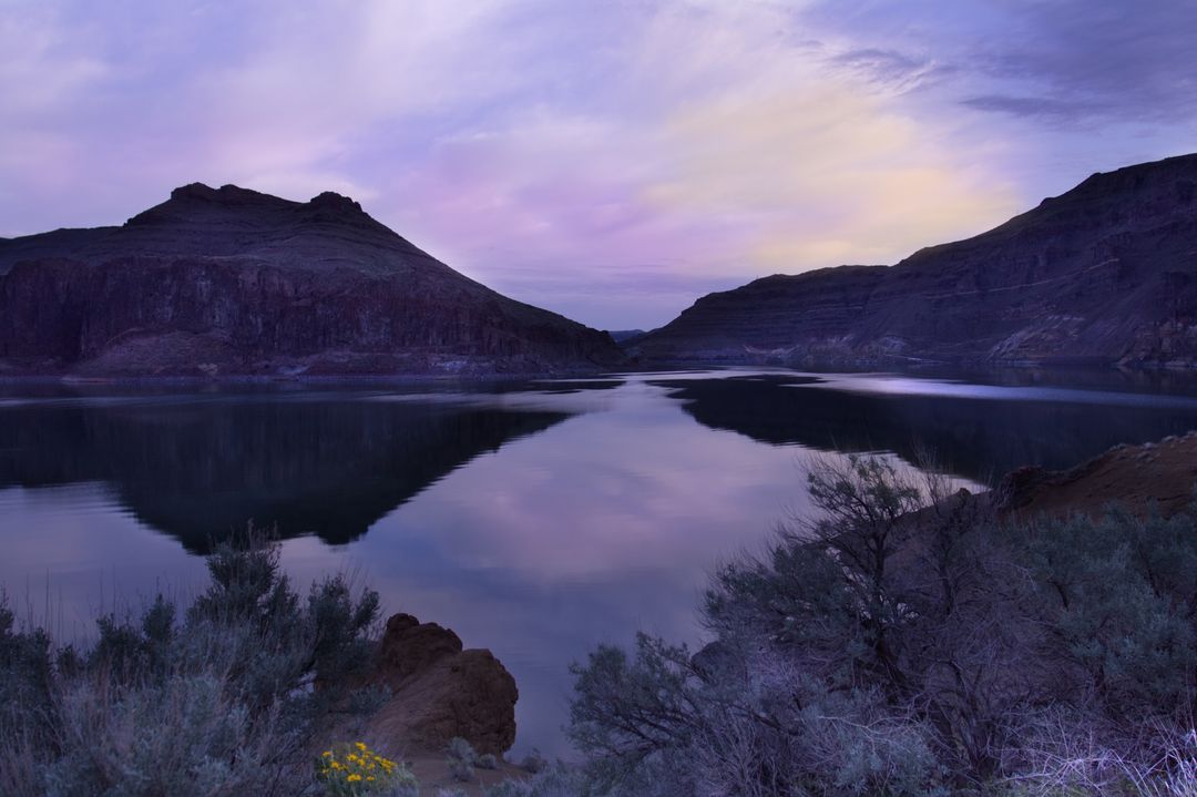Lavender Twilight Reflecting Over Desert Canyon Lake With Mirror Calm Water