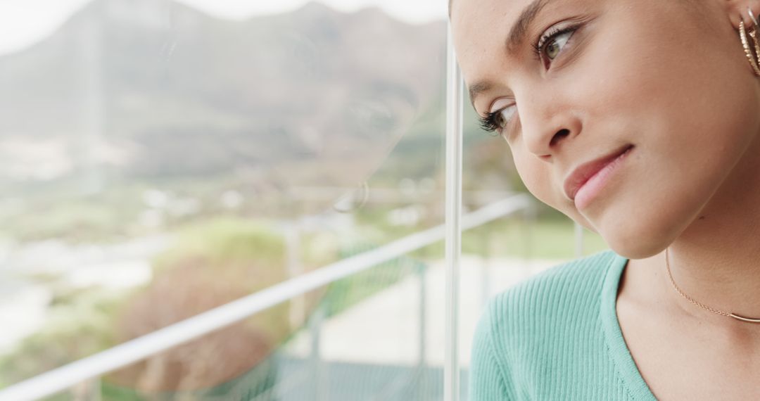 Thoughtful Woman Gazing Through Window with Scenic Background - Free Images, Stock Photos and Pictures on Pikwizard.com