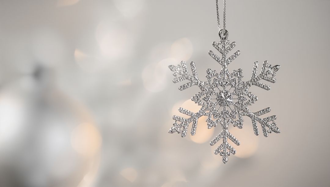 Hanging Silver Snowflake Ornament with Sparkling Crystals and Warm Bokeh Lights