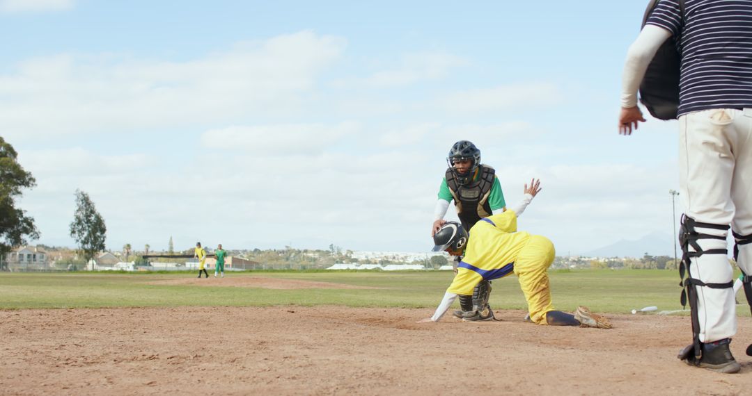 Baseball Player Sliding to Home Plate During Competitive Game