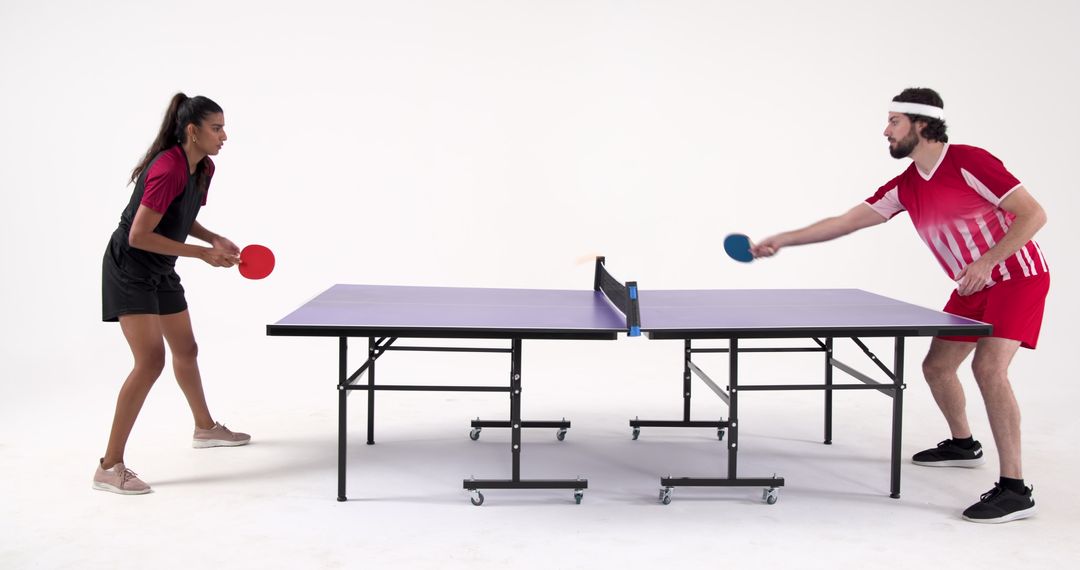 Diverse Athletes Competing at Table Tennis in Studio Setting