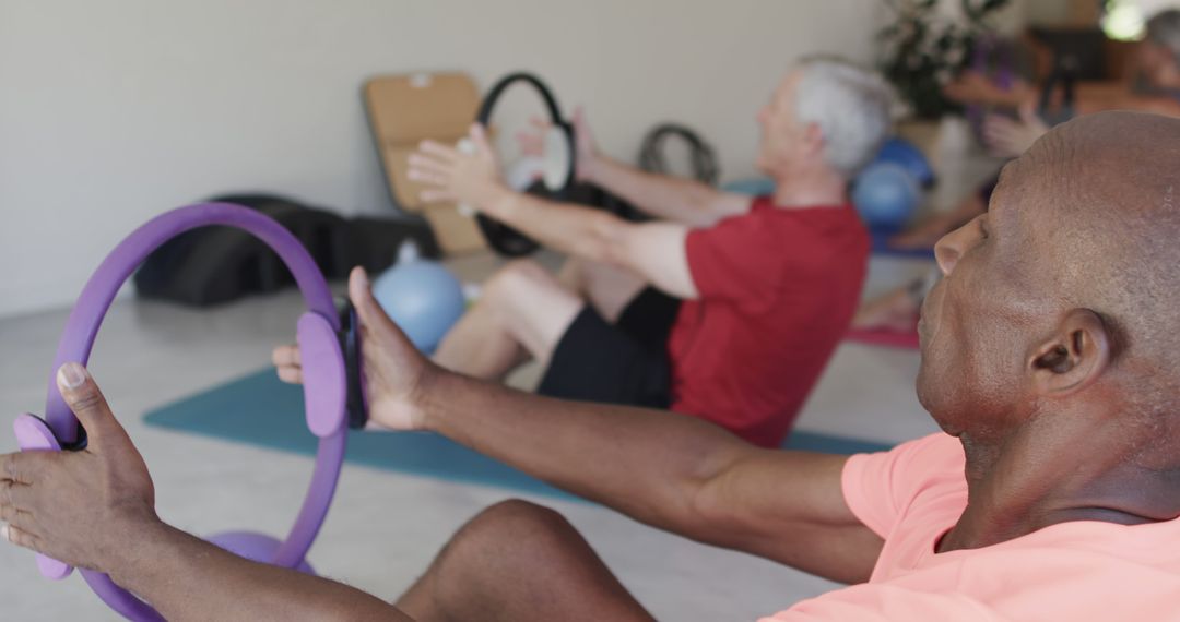 Senior Adults Practicing Pilates with Fitness Rings in Class - Free Images, Stock Photos and Pictures on Pikwizard.com