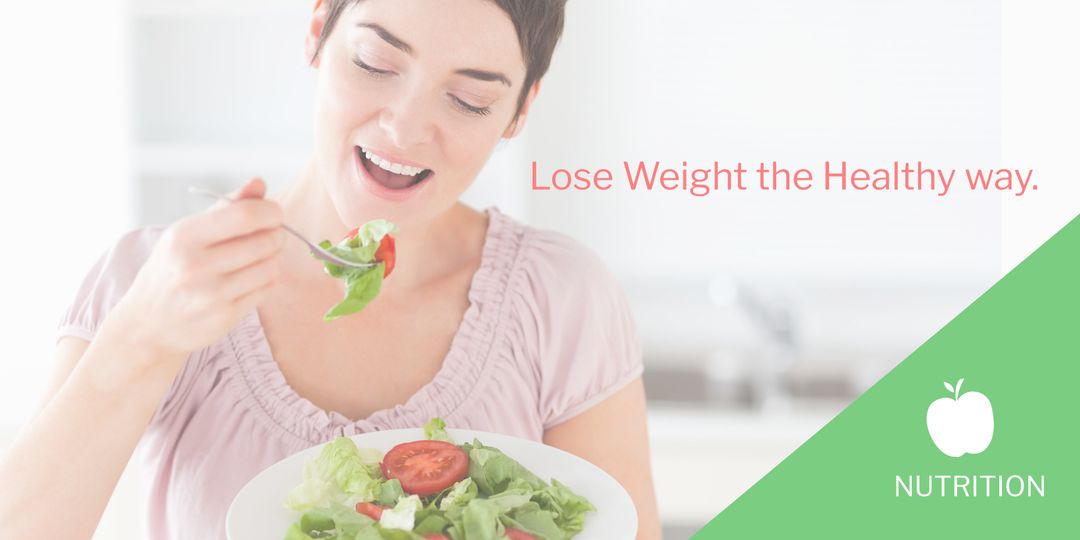 Smiling woman eating fresh salad for healthy living
