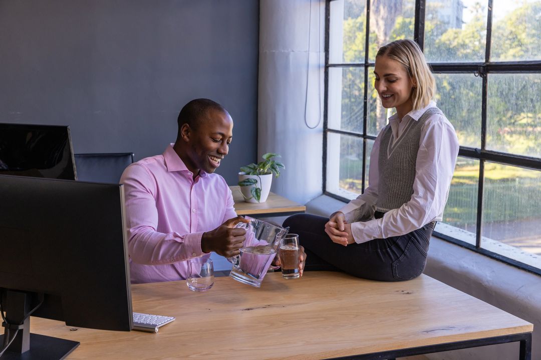 Diverse Colleagues Enthusiastically Share Refreshment Break at Work