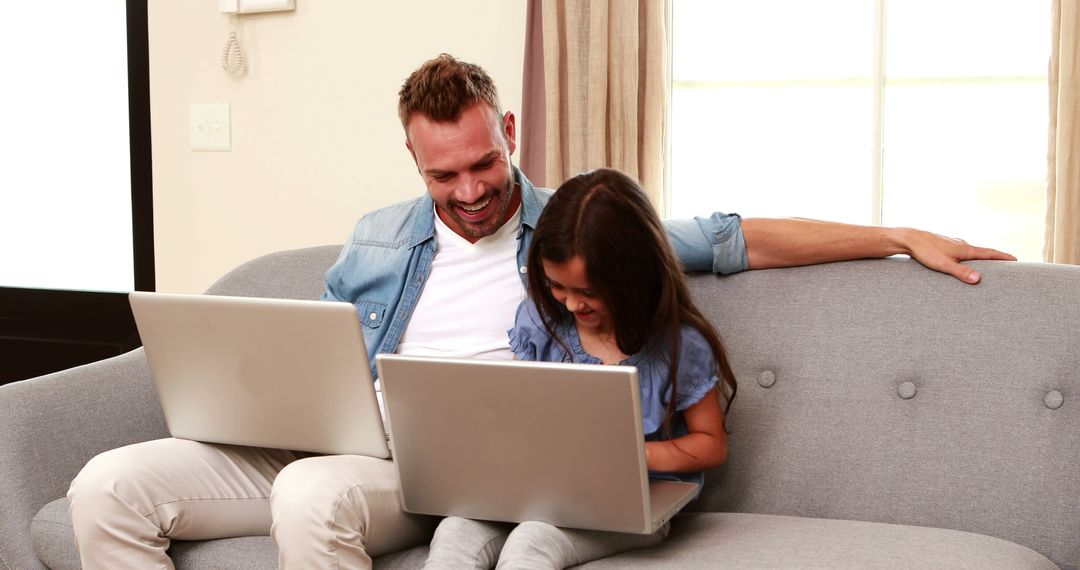 Father and Daughter Using Laptops on Couch at Home - Free Images, Stock Photos and Pictures on Pikwizard.com