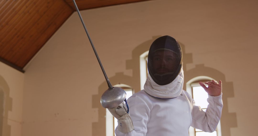 Focused Fencer Holding Epee During Training Indoors - Free Images, Stock Photos and Pictures on Pikwizard.com