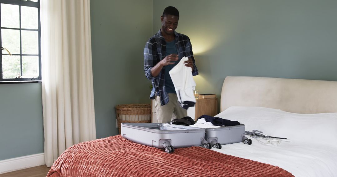 Man Packing Suitcase in Modern Cozy Bedroom