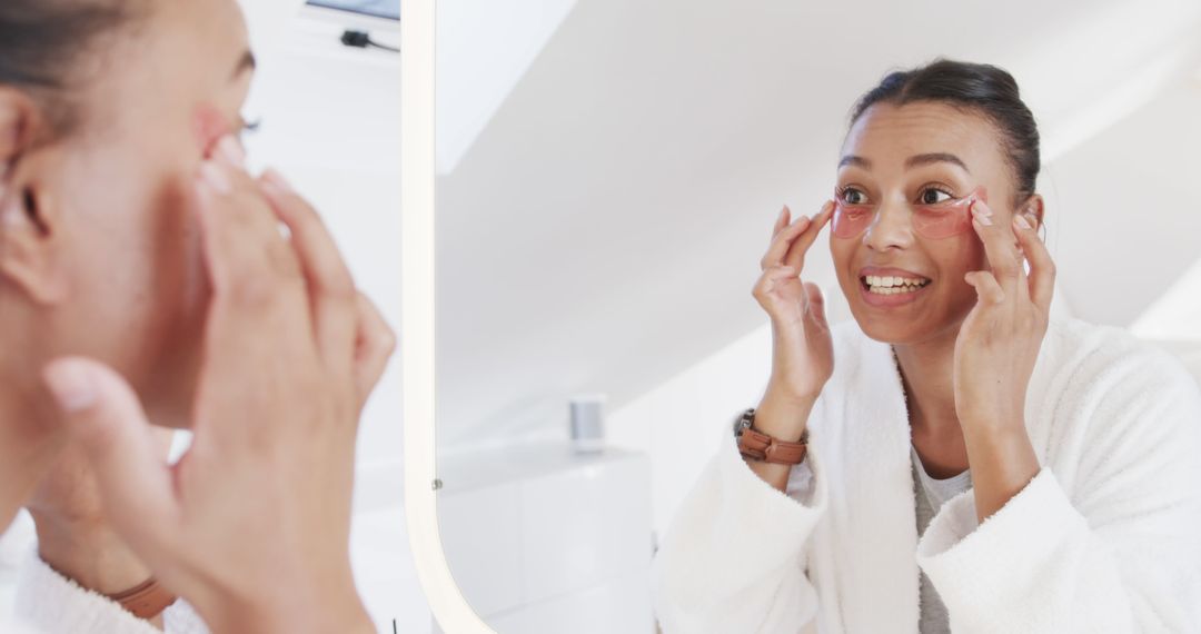 Woman Applying Under Eye Patches in Mirror for Skincare Routine - Free Images, Stock Photos and Pictures on Pikwizard.com