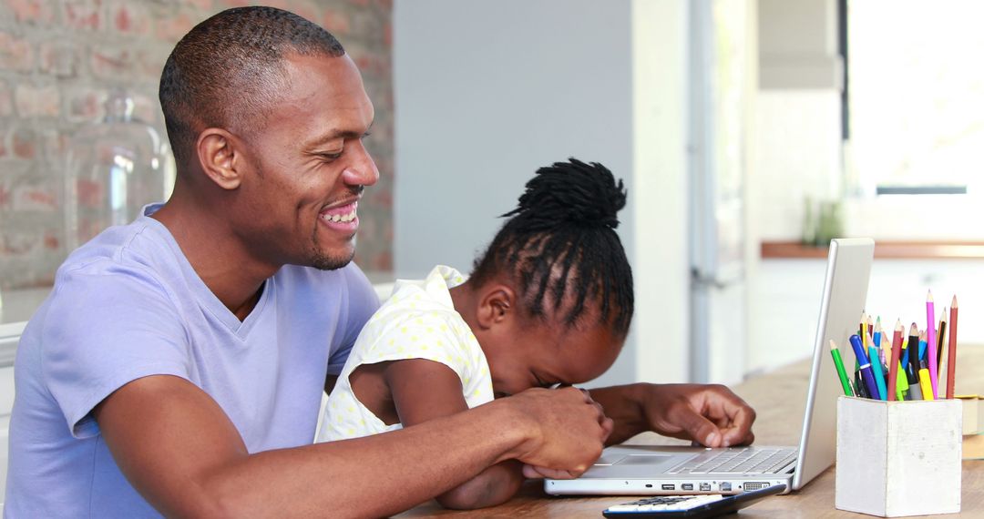 Father and Daughter Sharing a Laughter While Using Laptop at Home - Free Images, Stock Photos and Pictures on Pikwizard.com