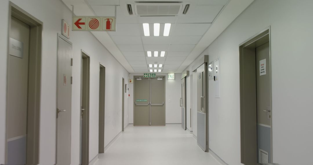 Empty Hospital Hallway with Emergency Exit Signs - Free Images, Stock Photos and Pictures on Pikwizard.com