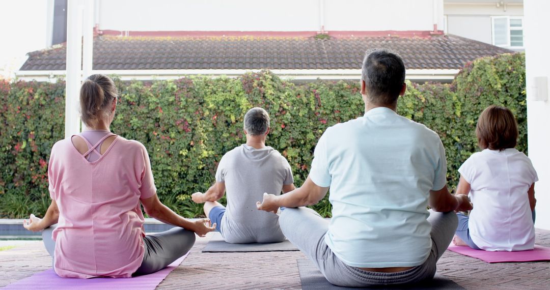 Diverse Adults Meditating During Outdoor Yoga Session
