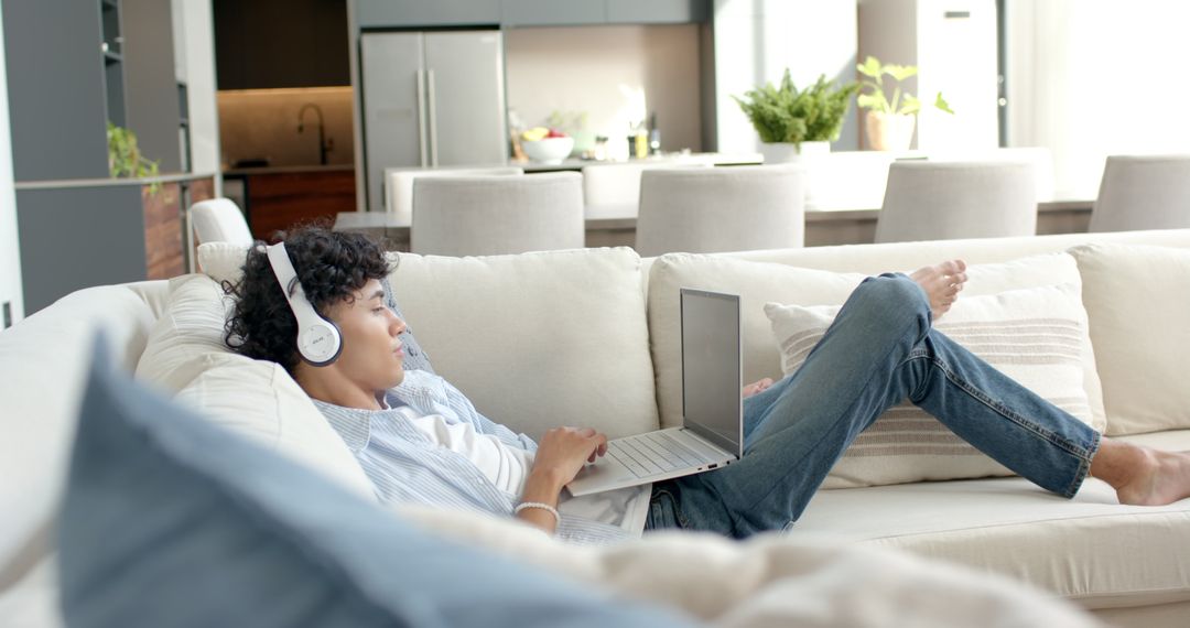 Relaxed Young Man Enjoying Technology While Lounging at Home
