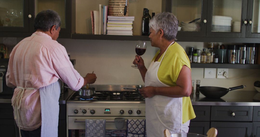 Senior Couple Cooking and Enjoying Wine in Kitchen - Free Images, Stock Photos and Pictures on Pikwizard.com