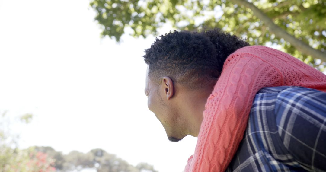 Two People Enjoying a Piggyback Ride Outdoors - Free Images, Stock Photos and Pictures on Pikwizard.com