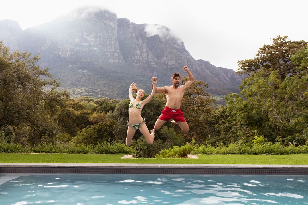 Couple jumping together in the swimming pool - Free Images, Stock Photos and Pictures on Pikwizard.com