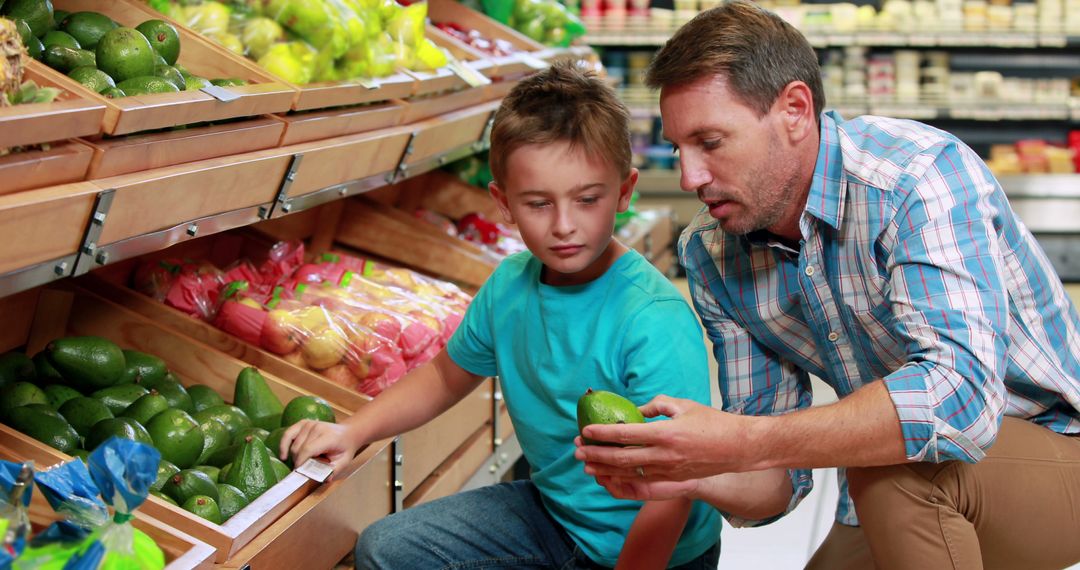 Father and Son Choosing Fresh Produce at Grocery Store - Free Images, Stock Photos and Pictures on Pikwizard.com