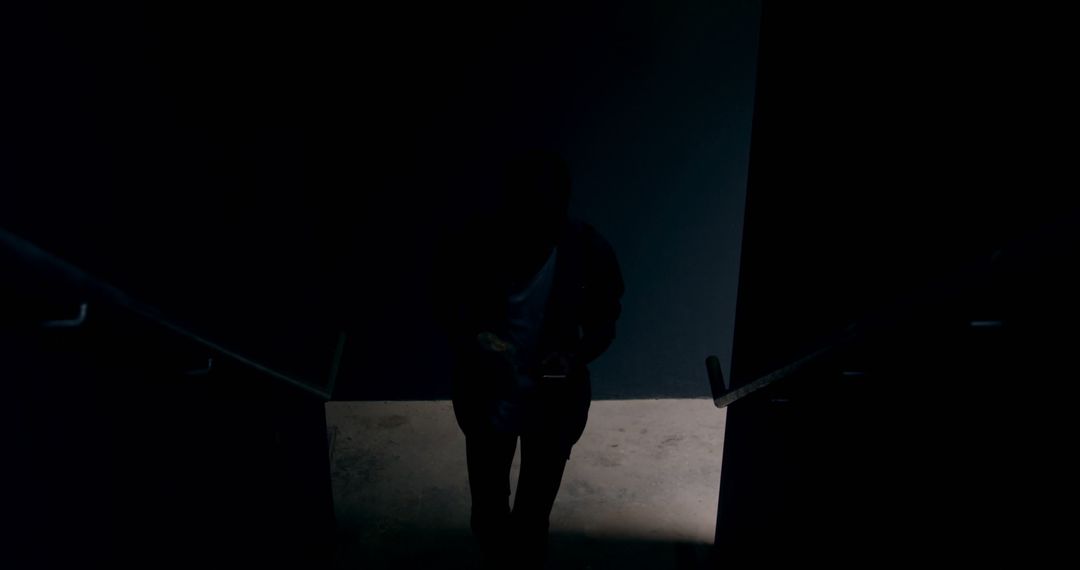 Dark Silhouette of Person Descending Stairs - Free Images, Stock Photos and Pictures on Pikwizard.com