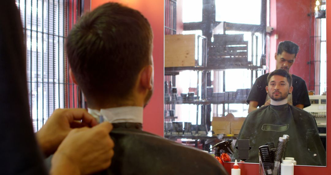 Barber Adjusting Cape Around Customer's Neck in Barbershop - Free Images, Stock Photos and Pictures on Pikwizard.com