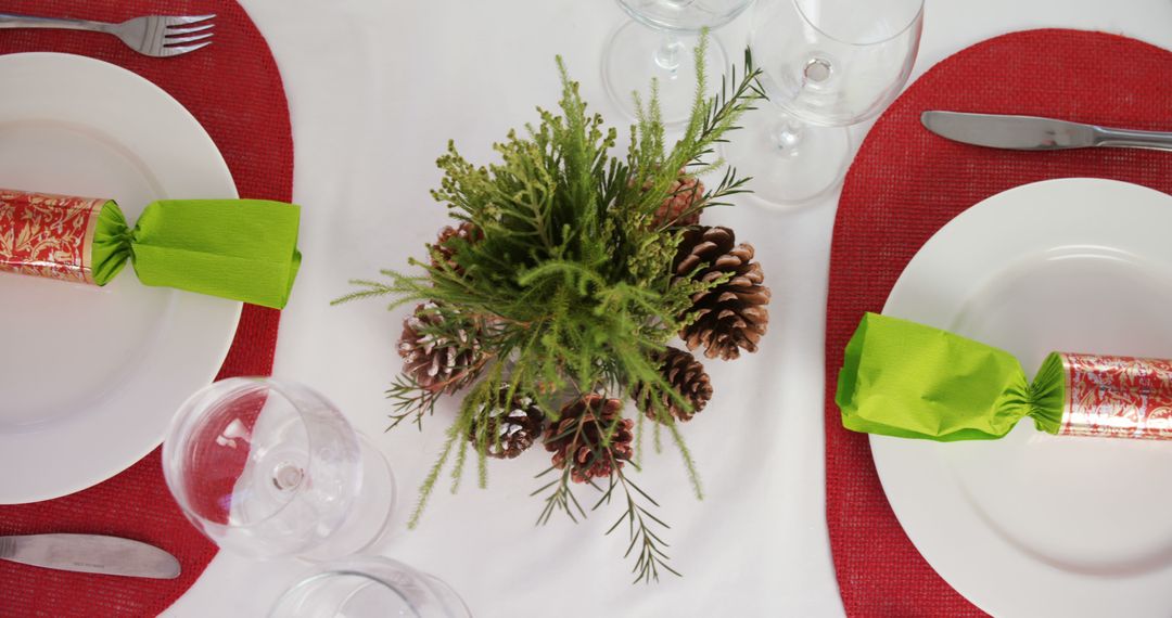 Festive Table Setting with Green Napkins and Pine Cones Decoration - Free Images, Stock Photos and Pictures on Pikwizard.com