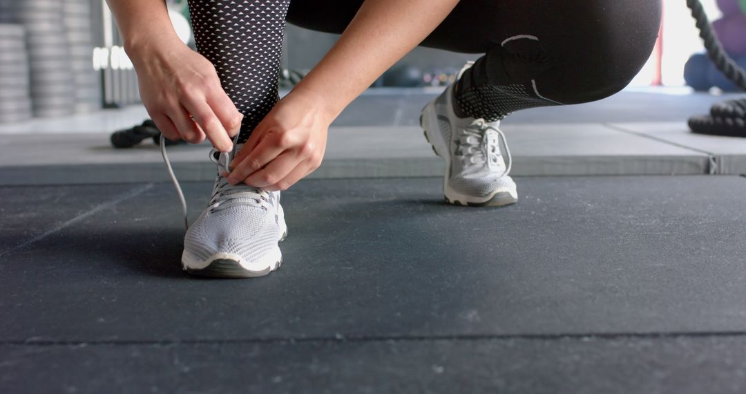 Woman Tying Shoelaces Before Gym Workout