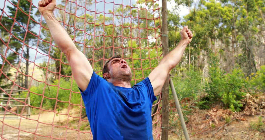 Atheltic Man in Blue Shirt Overcoming Obstacle in Outdoor Exercise Circuit - Free Images, Stock Photos and Pictures on Pikwizard.com