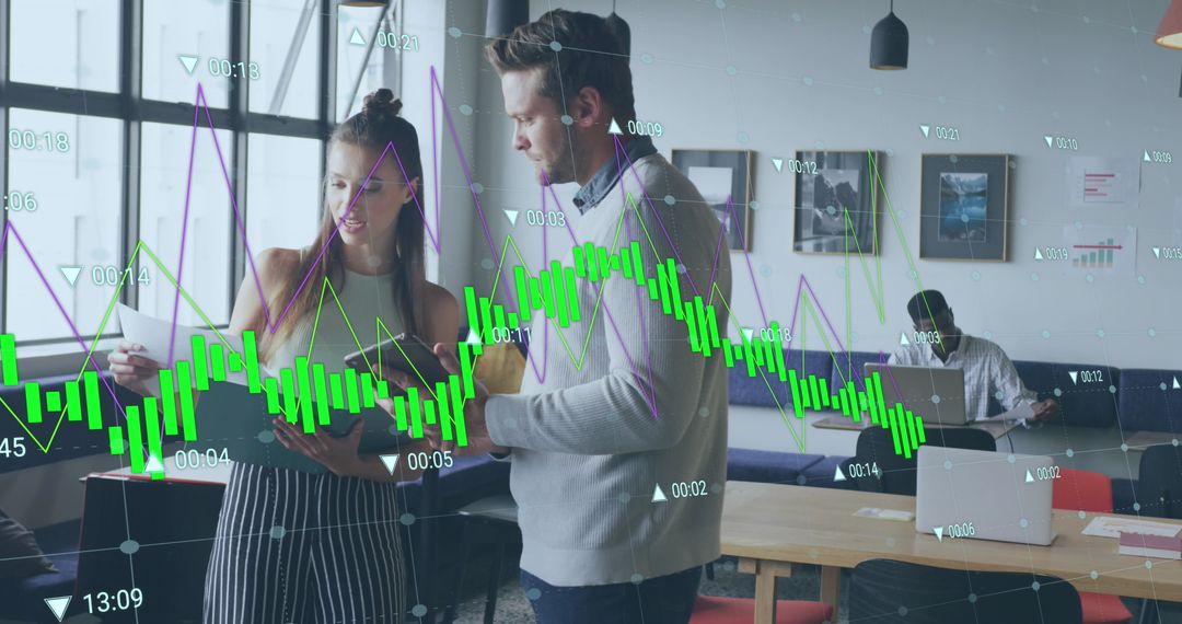 Colleagues Discussing Data Analytics in Modern Office Environment