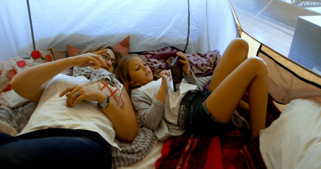 Mother and Daughter Relaxing Inside Cozy Tent - Free Images, Stock Photos and Pictures on Pikwizard.com