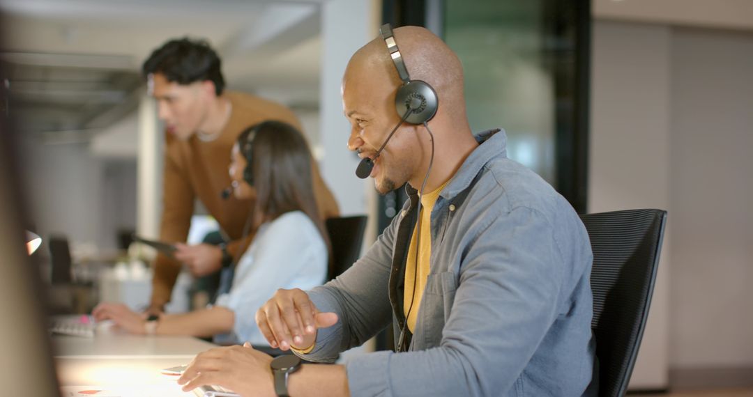 Delivering Customer Support: Diverse Team Collaborating in Open-Plan Office with Headsets