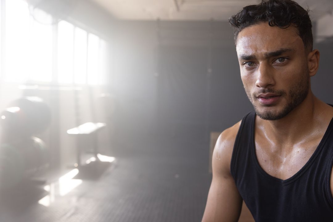 Focused Man Training in Gym with Determined Expression