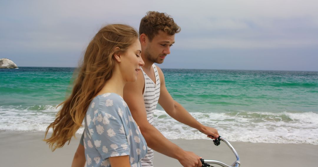 Happy Couple Enjoying Beach Walk with Bicycle