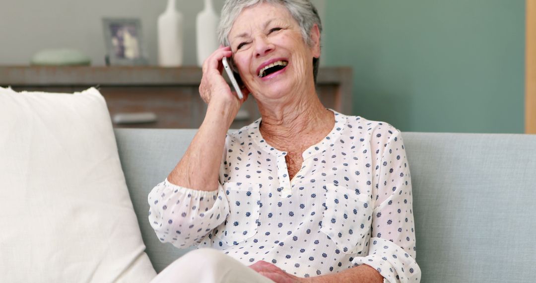 Senior Woman Laughing During Phone Call on Sofa - Free Images, Stock Photos and Pictures on Pikwizard.com