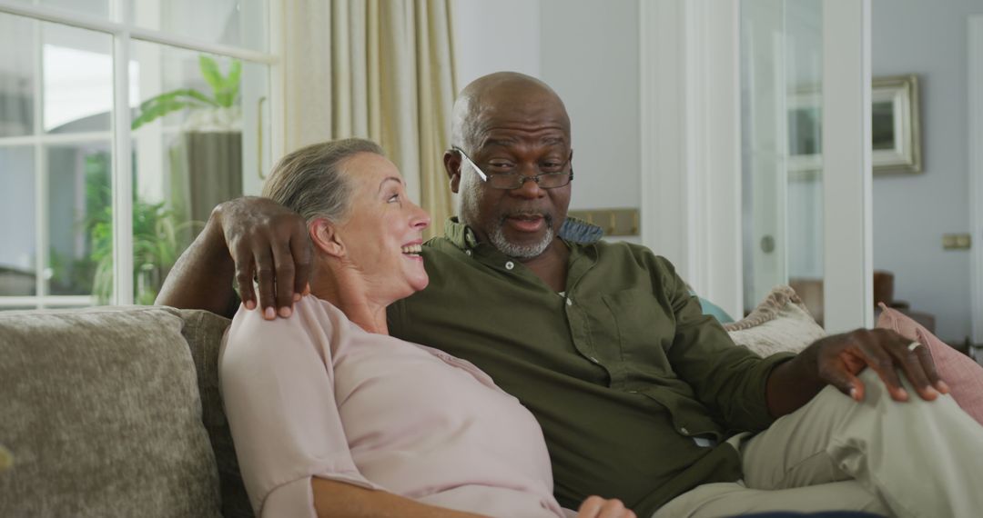 Caring Senior Couple Relaxing on Couch at Home - Free Images, Stock Photos and Pictures on Pikwizard.com