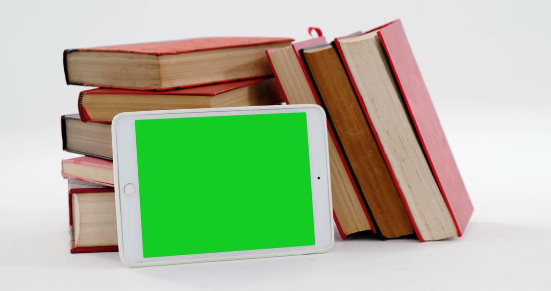 Tablet with Green Screen Next to Stack of Books - Free Images, Stock Photos and Pictures on Pikwizard.com