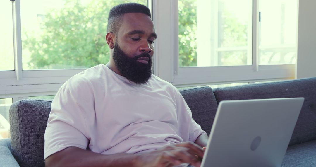 Casual Home Office: Man Working on Laptop on Spring Day