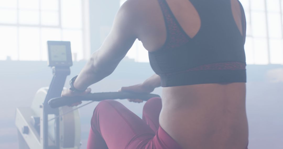 Woman Exercising on Rowing Machine in Fitness Studio - Free Images, Stock Photos and Pictures on Pikwizard.com