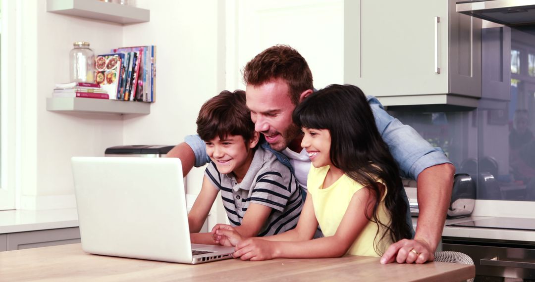 Happy Father and Children Using Laptop in Modern Kitchen - Free Images, Stock Photos and Pictures on Pikwizard.com