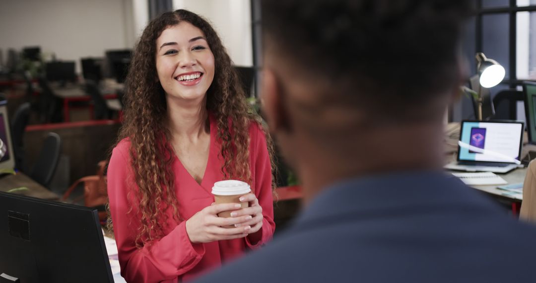 Smiling Businesswoman Holding Coffee in Modern Office - Free Images, Stock Photos and Pictures on Pikwizard.com