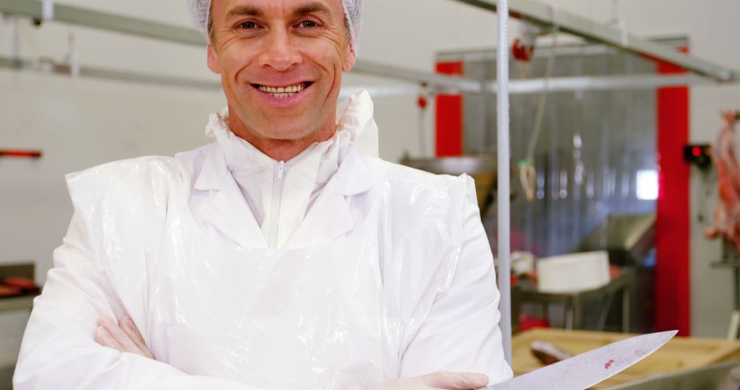 Butcher Holding Large Knife in Meat Processing Factory - Free Images, Stock Photos and Pictures on Pikwizard.com