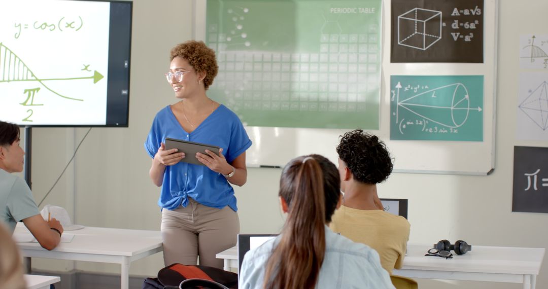 Teacher Using Tablet in High School Math Classroom