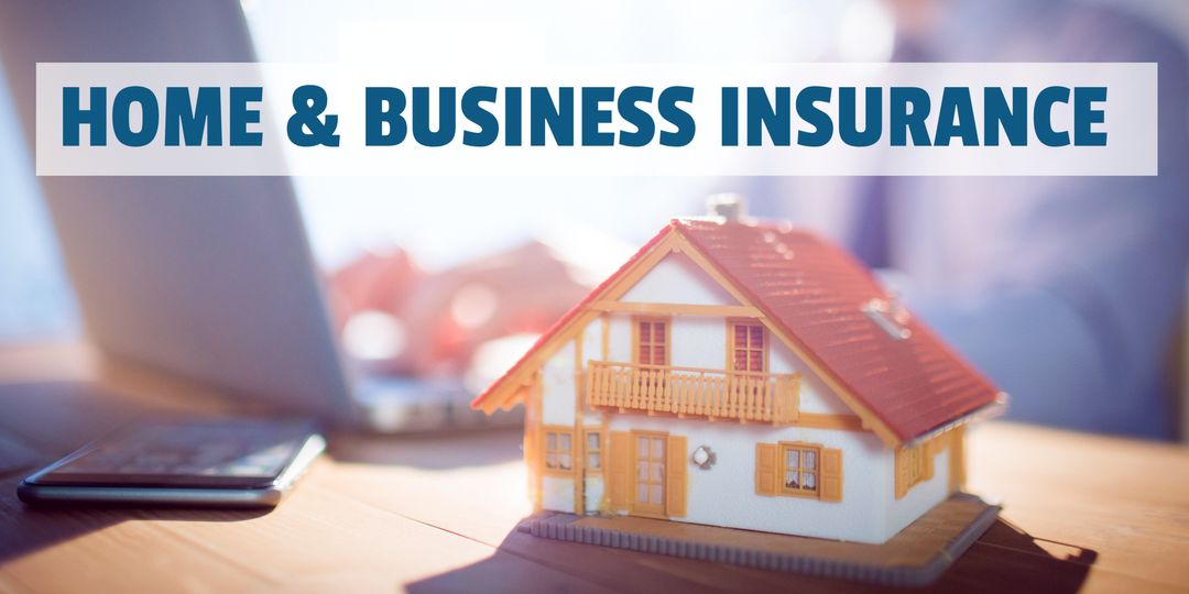 Home and business insurance concept with house model on desk